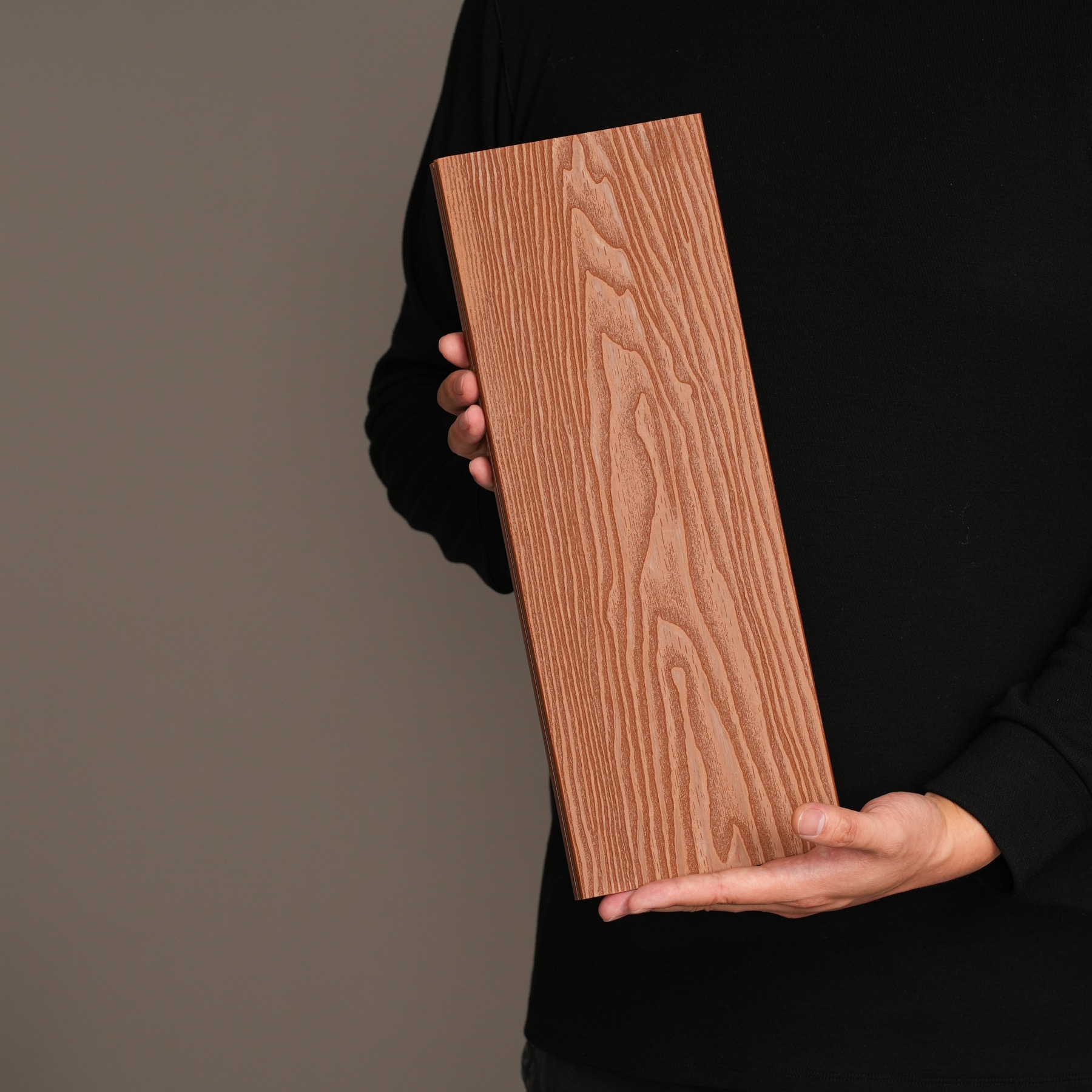 AN JU JIE exterior wall panel sample held against a dark studio background